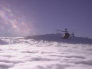 OH-58D above Hawaiian clouds